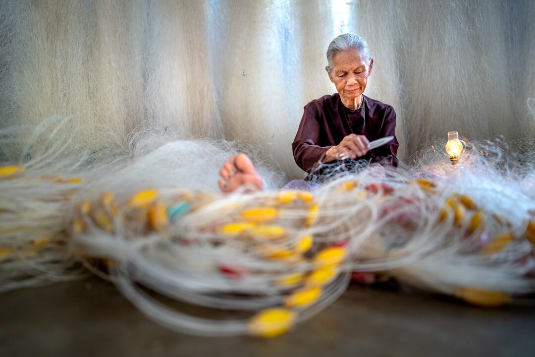 elderly woman knitting